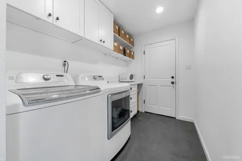 a view of a house with a bench in the backyard