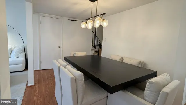 a view of a room with furniture and wooden floor