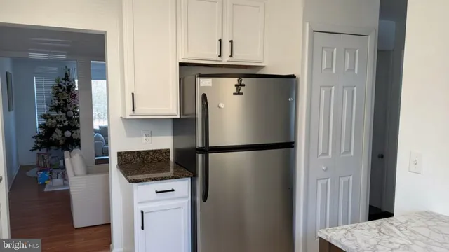 a kitchen with a refrigerator and a stove