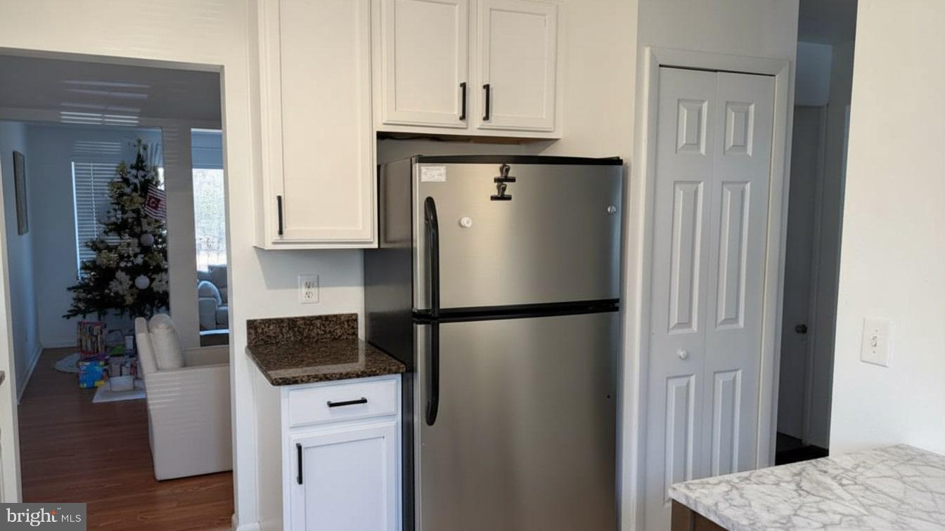 16031 Dorset Road, Unit 161 Laurel, MD 20707 - Photo 12 of 25 a kitchen with a refrigerator and a stove