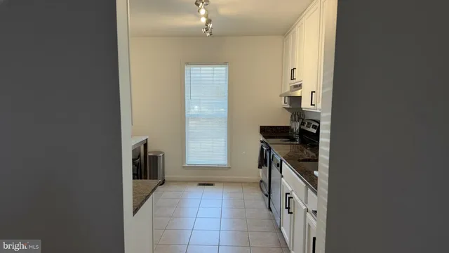 a kitchen with a sink and a stove