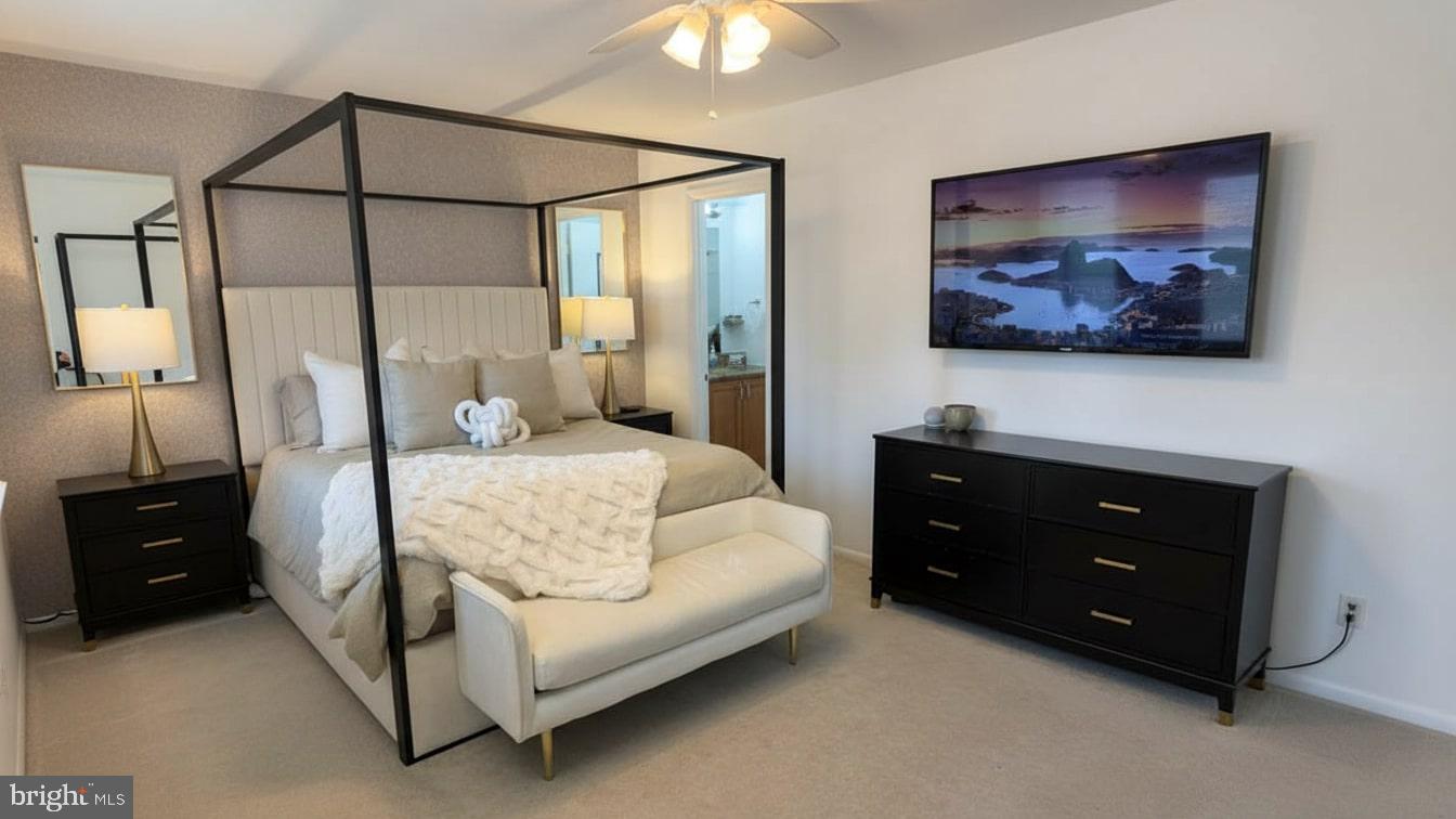 16031 Dorset Road, Unit 161 Laurel, MD 20707 - Photo 19 of 25 a bedroom with a bed and a chandelier