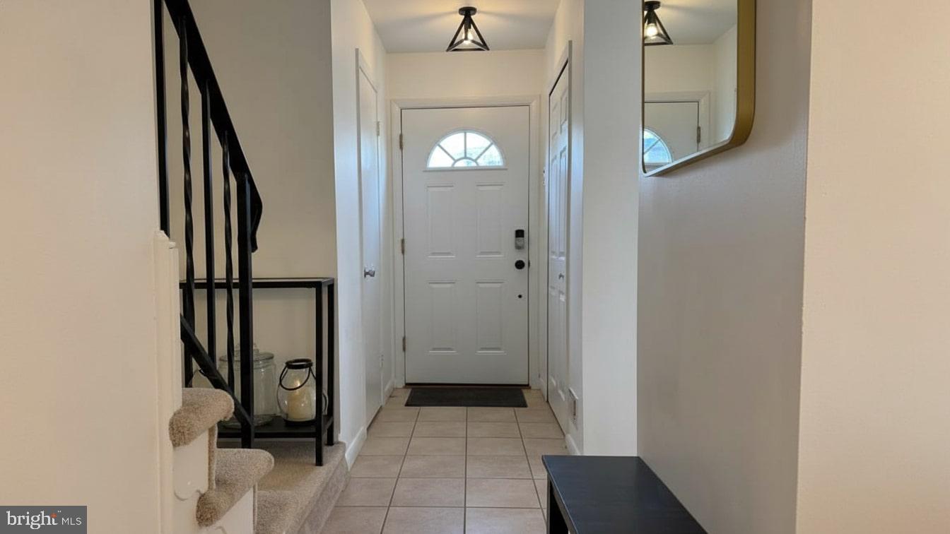 16031 Dorset Road, Unit 161 Laurel, MD 20707 - Photo 3 of 25 a view of a hallway with wooden floor and staircase