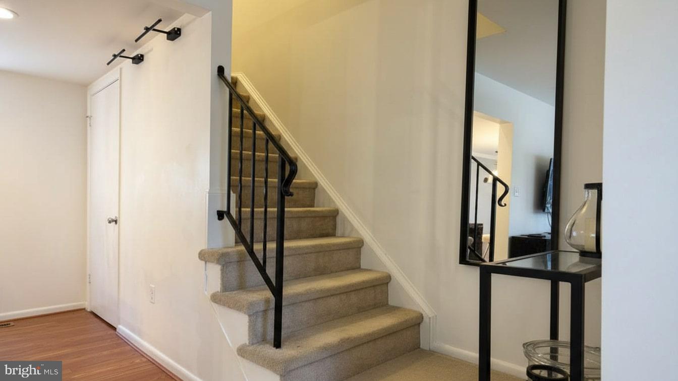 16031 Dorset Road, Unit 161 Laurel, MD 20707 - Photo 4 of 25 a view of staircase with wooden floor and white walls