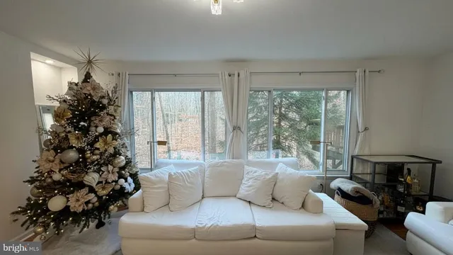 a living room with a large window and a couch