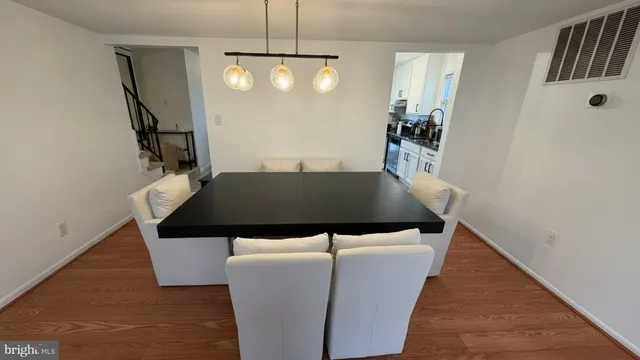 a view of a livingroom and dining room with furniture and wooden floor