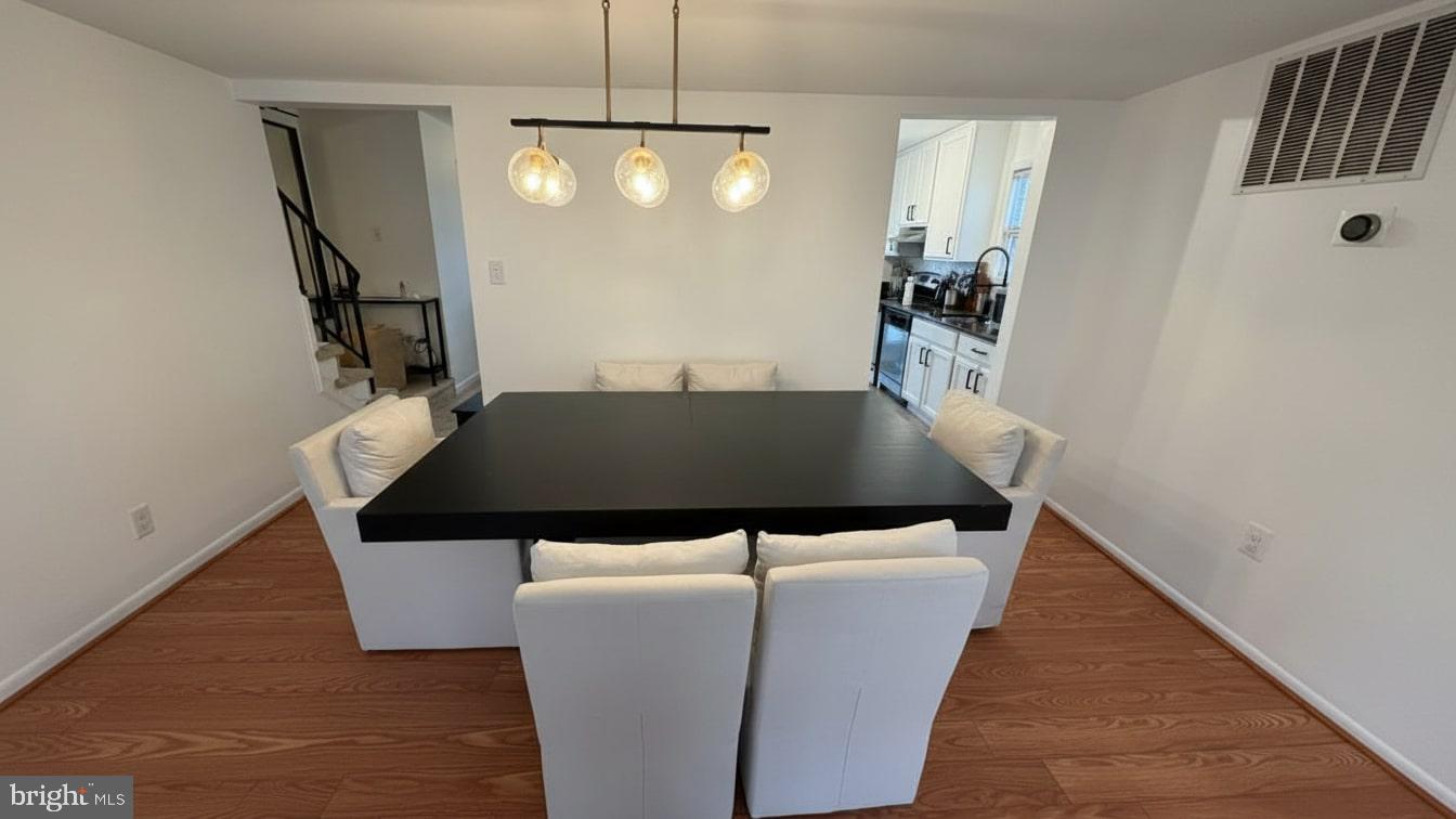16031 Dorset Road, Unit 161 Laurel, MD 20707 - Photo 9 of 25 a view of a livingroom and dining room with furniture and wooden floor