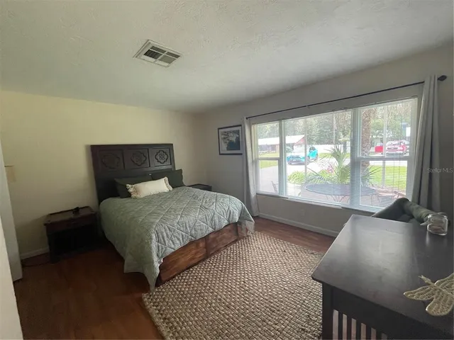 a bedroom with a bed and glass window
