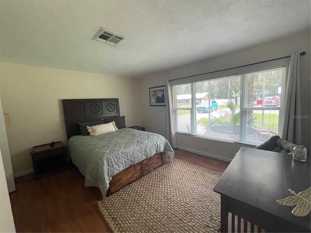 11636 Osceola Road Dunnellon, FL 34431 - Photo 12 of 34 a bedroom with a bed and glass window