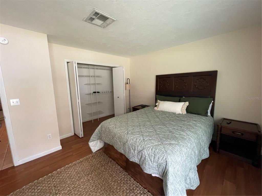 11636 Osceola Road Dunnellon, FL 34431 - Photo 13 of 34 a bedroom with a bed and wooden floor