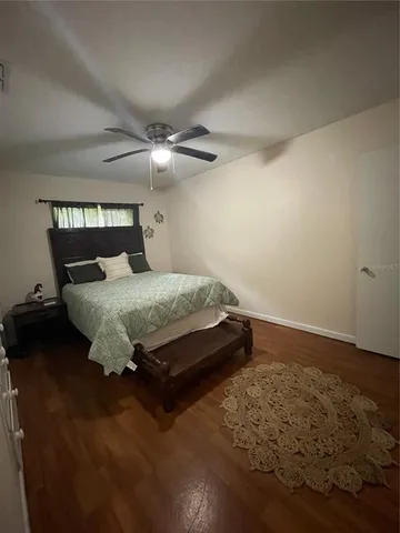 a bedroom with a bed and a ceiling fan