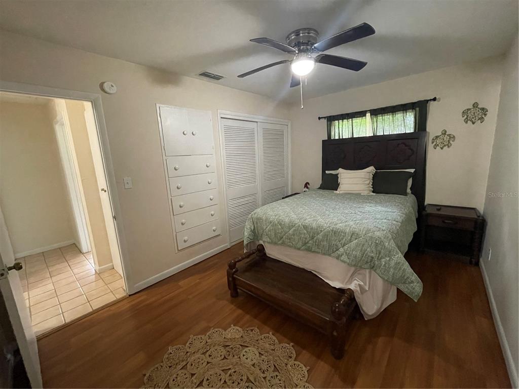 11636 Osceola Road Dunnellon, FL 34431 - Photo 17 of 34 a bedroom with a bed and a mirror on the dresser