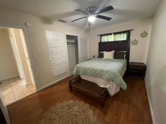 a room with a bed and a mirror on the dresser