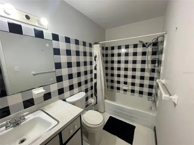 a bathroom with a sink a toilet a shower and a mirror