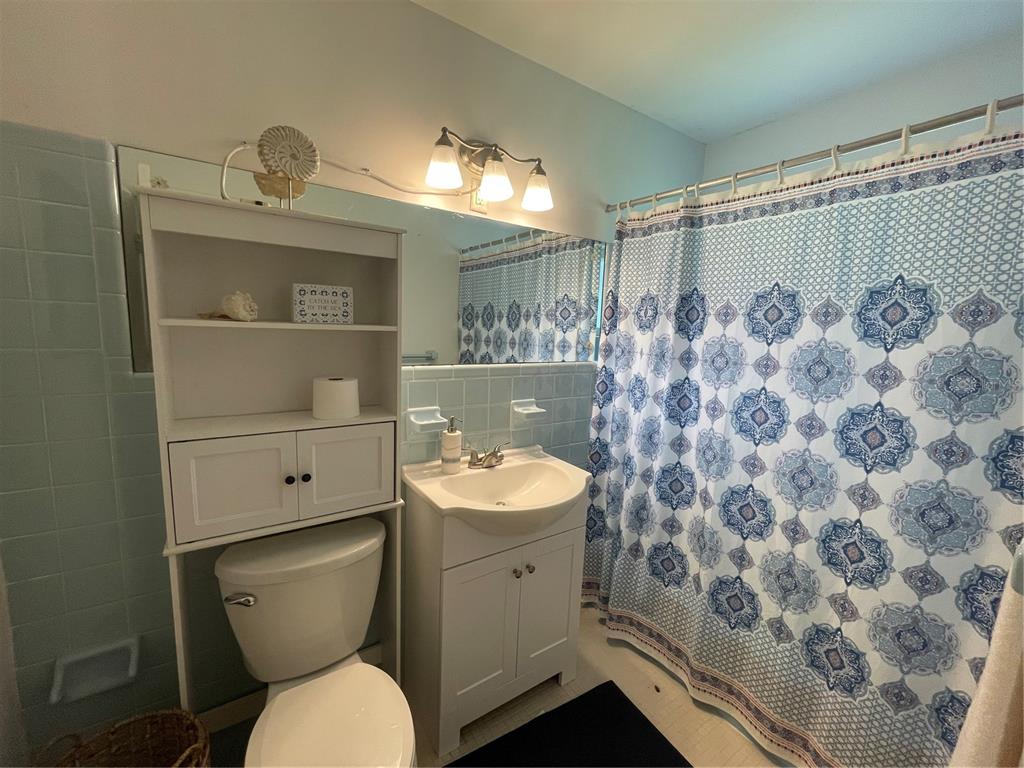 11636 Osceola Road Dunnellon, FL 34431 - Photo 24 of 34 a bathroom with a toilet a sink and mirror