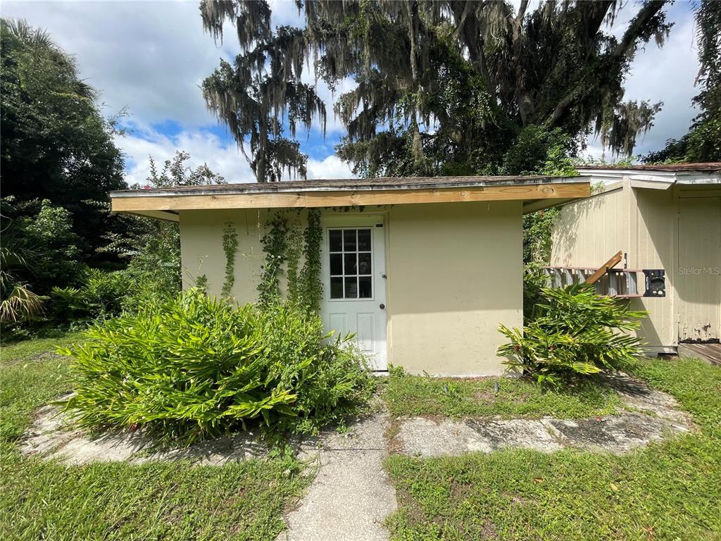 11636 Osceola Road Dunnellon, FL 34431 - Photo 29 of 34 front view of a house with a yard and potted plants