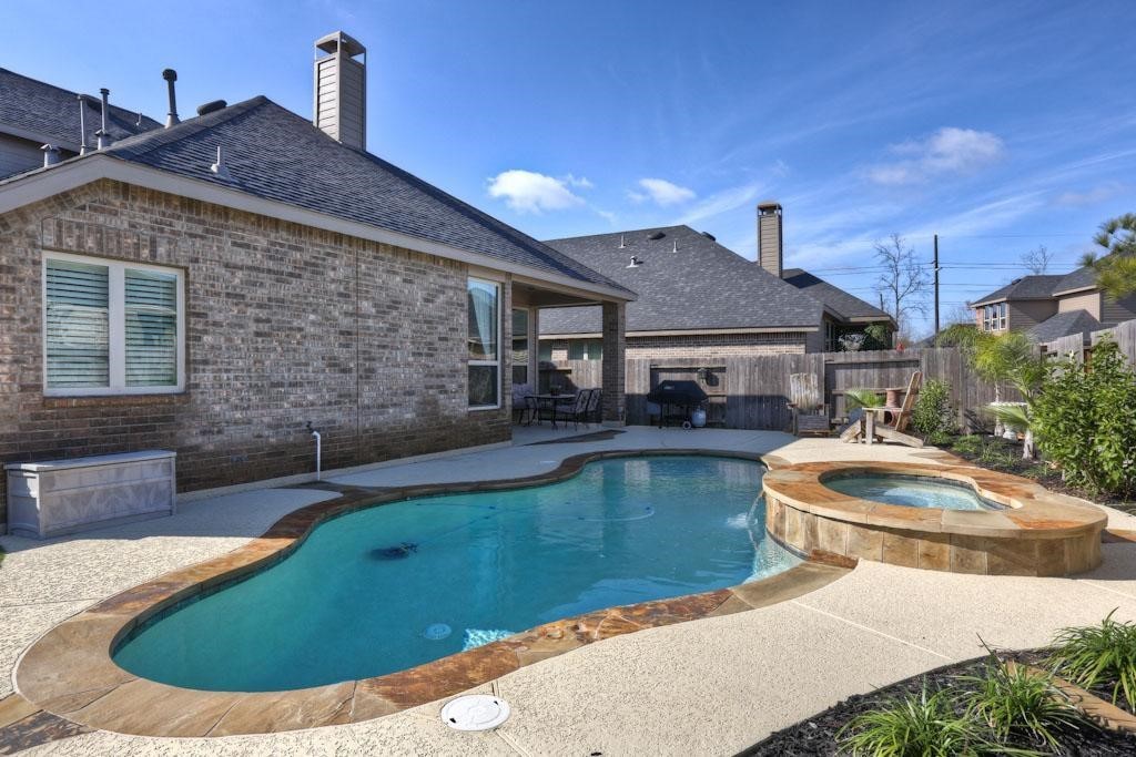 8111 Little Scarlet Street Conroe, TX 77385 - Photo 2 of 24 a view of a house with swimming pool and sitting area