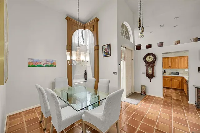a view of an outdoor dining space with a table and chairs