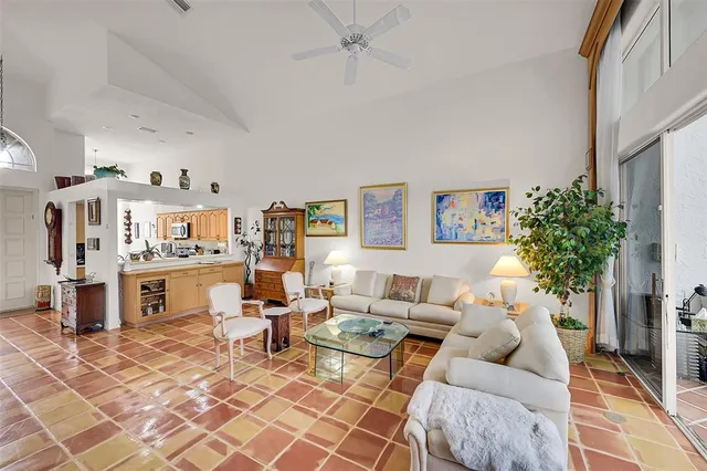 a large bedroom with a large bed and a chandelier
