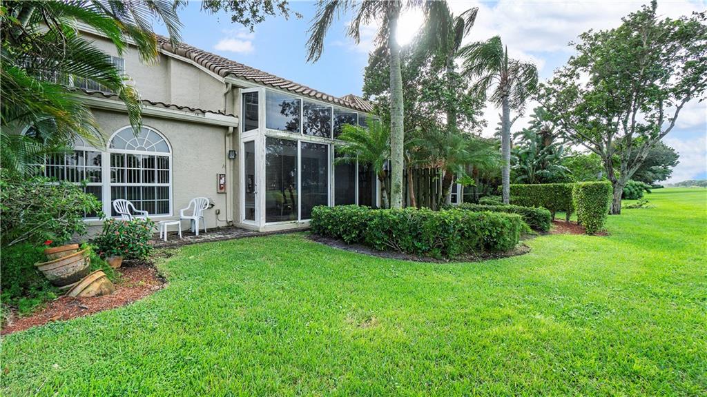 17210 Boca Club Boulevard, Unit 103 Boca Raton, FL 33487 - Photo 13 of 15 a view of a house with backyard and garden