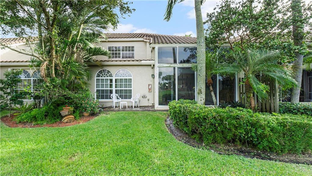 17210 Boca Club Boulevard, Unit 103 Boca Raton, FL 33487 - Photo 14 of 15 front view of a house with a yard