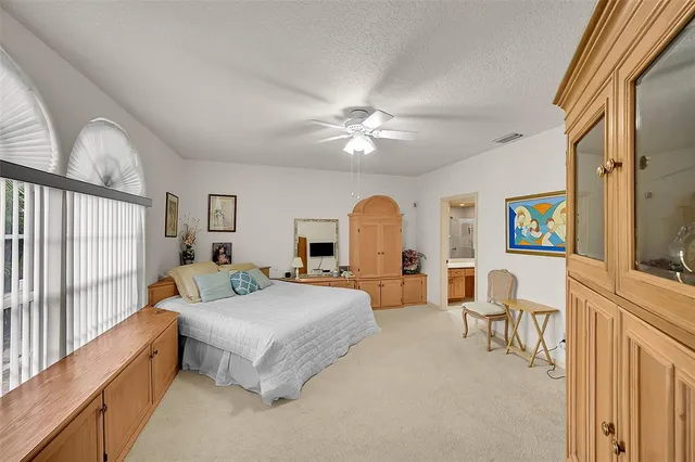 a spacious bathroom with a double vanity sink a large mirror and a bathtub