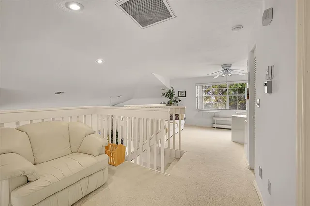 a living room with a large bed and a chandelier