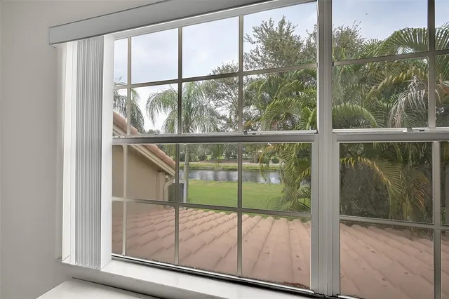 a front view of a house with a garden and plants