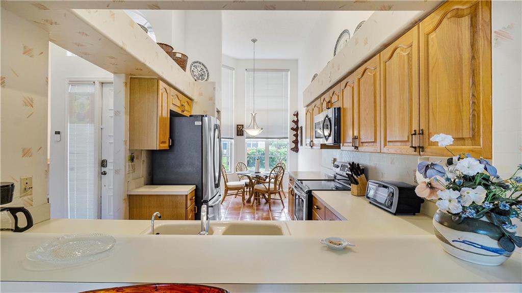 17210 Boca Club Boulevard, Unit 103 Boca Raton, FL 33487 - Photo 4 of 15 a bedroom with furniture and a large window