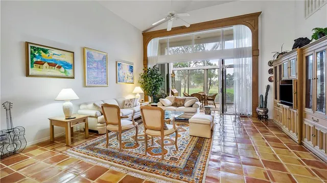 a living room with furniture and dining area