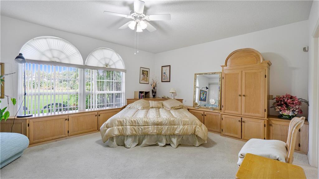 17210 Boca Club Boulevard, Unit 103 Boca Raton, FL 33487 - Photo 7 of 15 a bed room with a bed and a chandelier