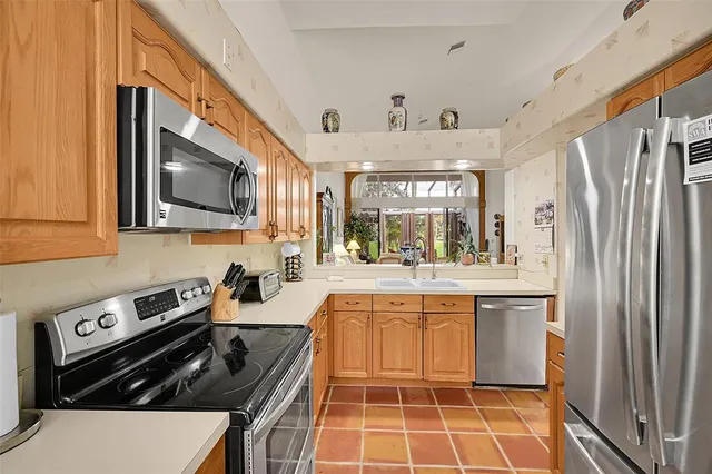 a view of a livingroom with wooden floor and furniture