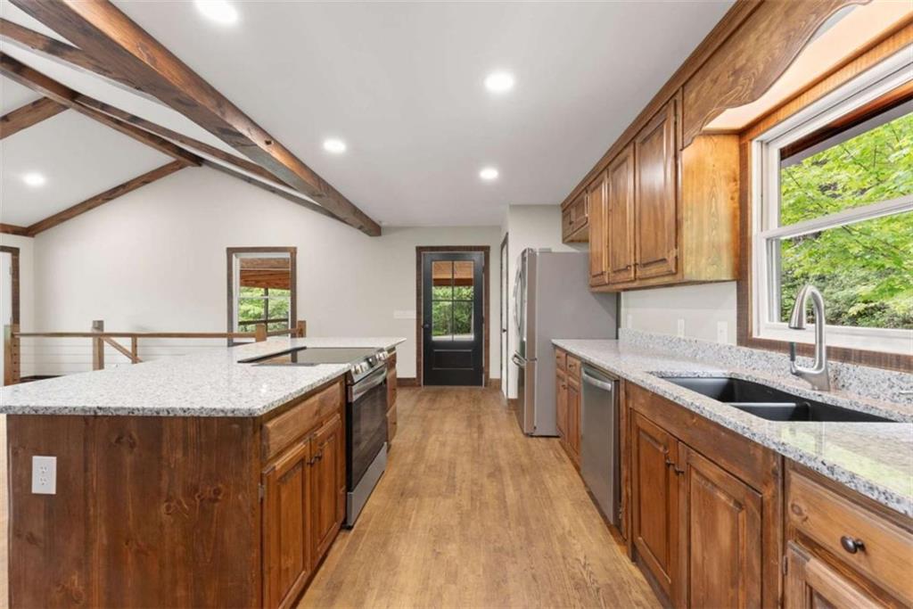 707 South Fern Cove Road Sautee Nacoochee, GA 30571 - Photo 16 of 60 a kitchen with stainless steel appliances granite countertop sink stove top oven and cabinets