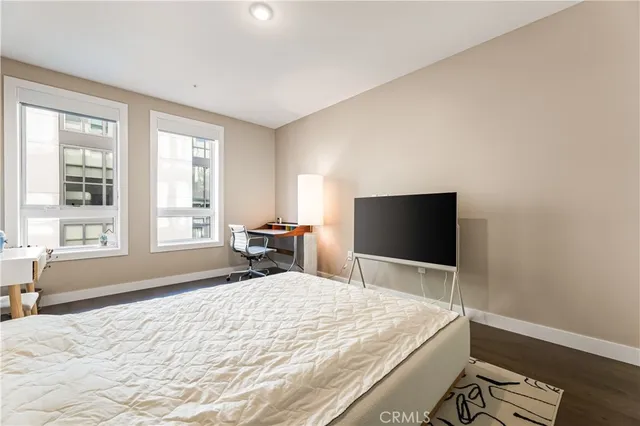 a bedroom with a bed and a flat screen tv