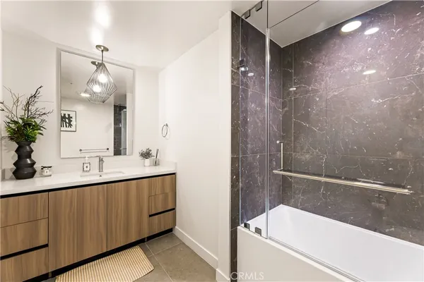 a bathroom with a tub sink and mirror