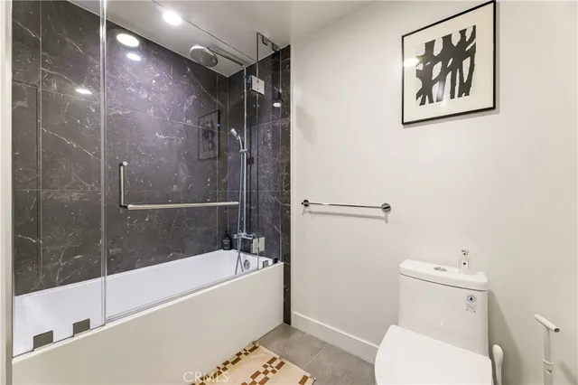a bathroom with a toilet and a bathtub