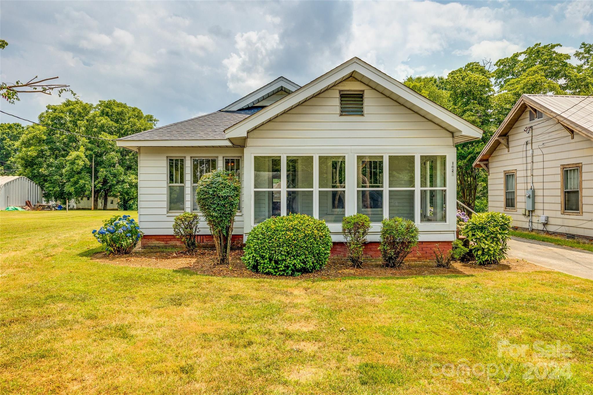 a front view of a house with swimming pool and porch