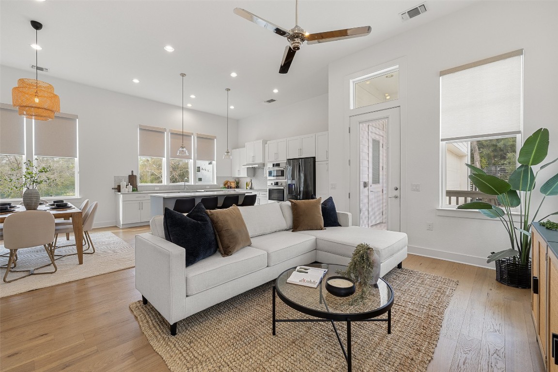 a living room with furniture and a wooden floor