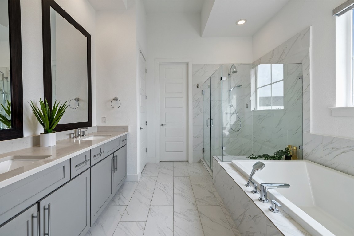 4400 Night Owl Lane Austin, TX 78723 - Photo 23 of 40 a bathroom with a tub sink and mirror