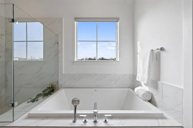 a bathroom with a granite countertop sink a toilet and a bathtub