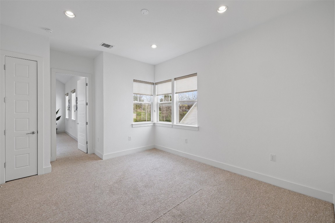 4400 Night Owl Lane Austin, TX 78723 - Photo 29 of 40 an empty room with a window and a bathroom