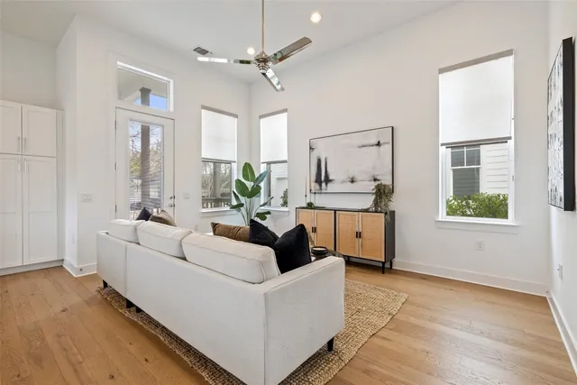 a kitchen with stainless steel appliances granite countertop a stove a sink a oven a dining table with chairs and white cabinets