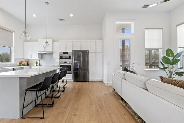 a kitchen with refrigerator and window