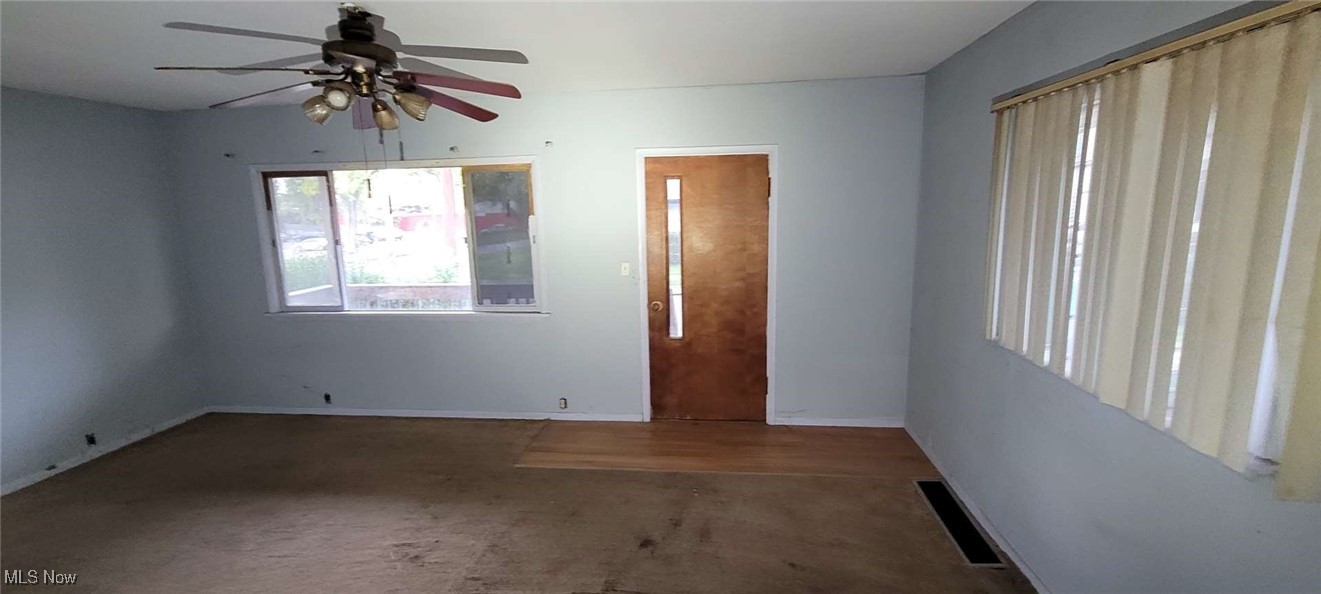 6816 Rathbun Avenue Cleveland, OH 44105 - Photo 3 of 10 Empty room featuring ceiling fan and carpet