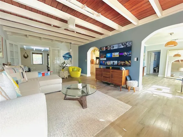 a living room with furniture and a chandelier