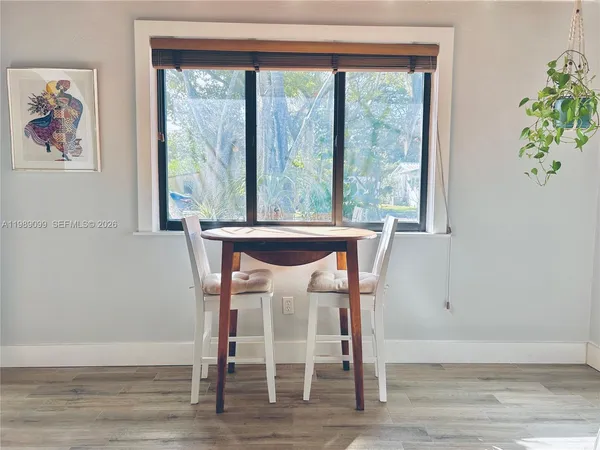 a view of a dining room with furniture and window