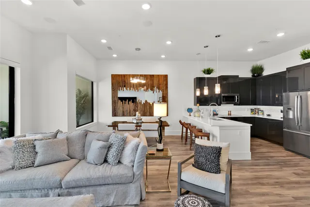 a living room with furniture and view of kitchen