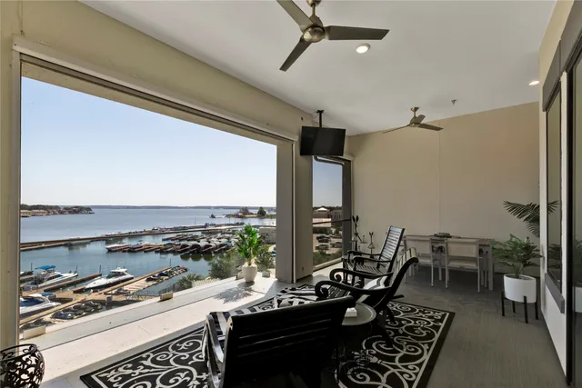 a kitchen with stainless steel appliances granite countertop a stove and a view of living room