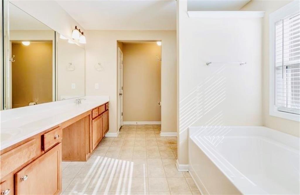 5430 Crestwick Way Cumming, GA 30040 - Photo 12 of 23 a spacious bathroom with a tub and shower