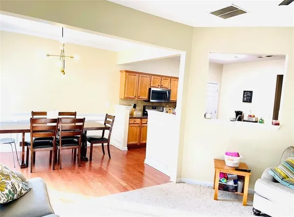 a dining room with furniture and wooden floor